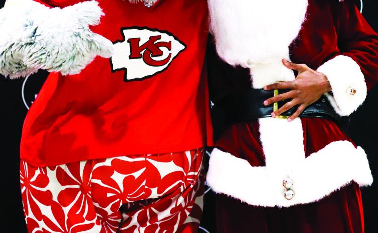 (Above) KC Chiefs Justin Reid (dressed as Santa) with Chiefs’ mascot, KC Wolf.