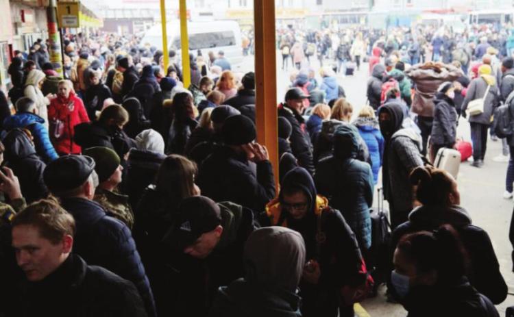 People wait for buses at a bus station as they attempt to evacuate the city on Feb. 24, 2022, in Kyiv, Ukraine. Overnight, Russia began a largescale attack on Ukraine, with explosions reported in multiple cities and far outside the restive eastern regions held by Russian-backed rebels (Photo by Pierre Crom/Getty Images).