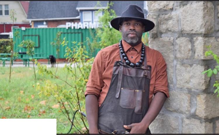 Phillip Ramsey, a master gardener, stands in the Ruby Jeans Community Garden at 29th Street and Wabash Avenue in Kansas City, Missouri, where he grows and distributes fresh produce to neighbors. (Thomas White/ The Beacon)