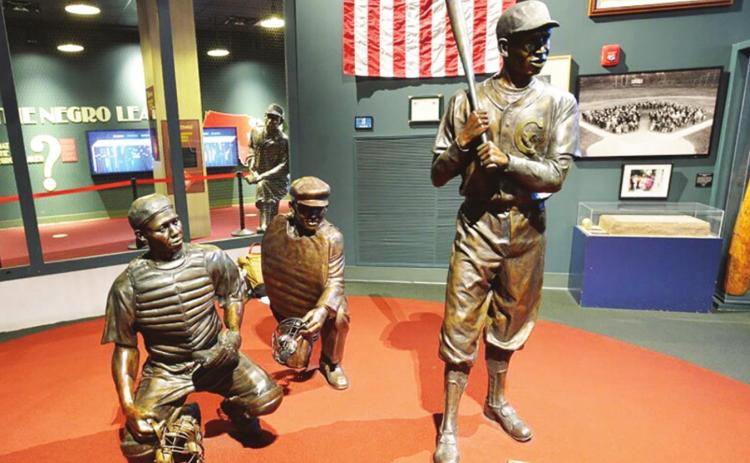 Bronze figures of historic Negro Leagues players greet visitors to the Negro Leagues Baseball Museum in Kansas City, Mo. photo/Carlos Moreno