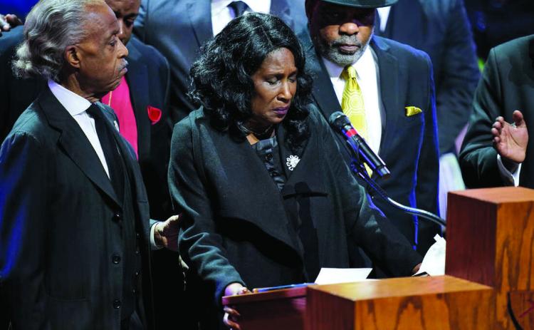 RowVaughn Wells speaks alongside her husband Rodney Wells and the Rev. Al Sharpton during the funeral service for her son Tyre Nichols at Mississippi Boulevard Christian Church in Memphis, Tenn., on Wednesday. Andrew Nelles/The Tennessean via AP, Pool