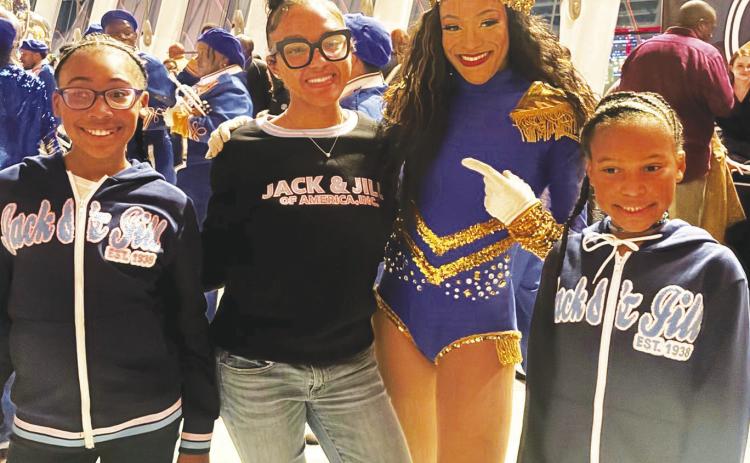 Jack and Jill members Jadyn Parson, Aniya Byrd and Jordyn Parson pose with a cast member of DRUMLine LIVE after the Feb. 8 performance at the Kauffman Center for the Performing Arts RELATED STORY, PHOTOS INSIDE, P. 3