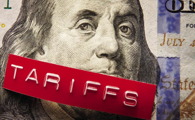 Tariffs label on a hundred dollar bill (photo via NNPA)