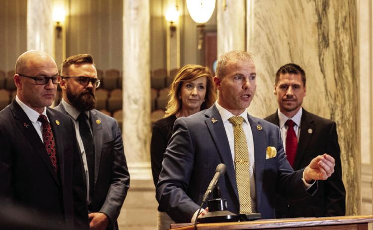 Sen. Rick Brattin, R-Harrisonville, speaking, and, from left, Sens. Denny Hoskins, Nick Schroer, Jill Carter and Andrew Koenig, members of the Freedom Caucus, during a Jan. 11 news conference (Annelise Hanshaw/Missouri Independent).