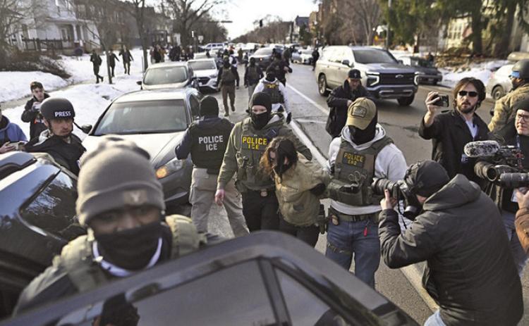 U.S. Immigration and Customs Enforcement officers detain an observer after making arrests in January in Minneapolis. Bills in more than half a dozen states would prohibit ICE agents at the polls, which is already illegal under federal law (Missouri Independent)
