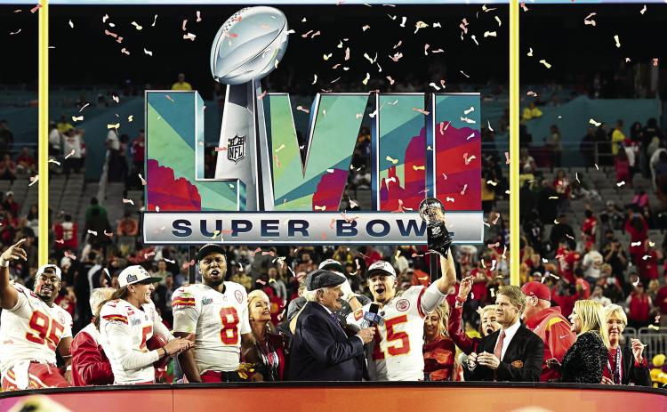 Kansas City Chiefs QB Patrick Mahomes surrounded by some of his teammates, staff and owner Clark Hunt hoists the Lombardi Trophy as he is being interviewed following Sunday’s victory over the Philadelphia Eagles at State Farm Stadium in Glendale, Ariz. photo courtesy, kcchiefs