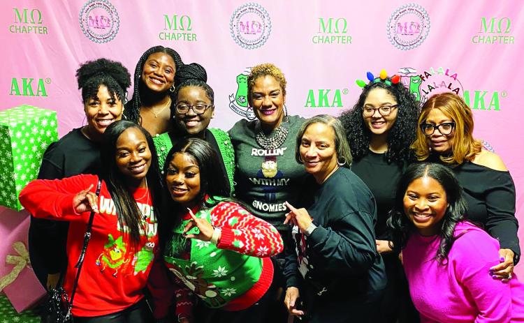 Mu Omega chapter members celebrating at the Jingle &amp; Mingle fundraising event