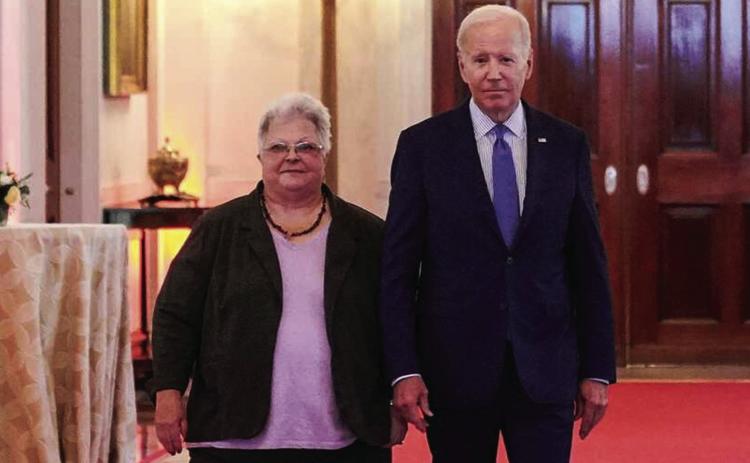 President Biden arrives with Susan Bro, mother of Charlottesville victim Heather Heyer, to deliver a keynote speech at the “United We Stand” summit to counter the effects of hate-fueled violence in the East Room of the White House on Thursday. MANDEL NGAN/AFP via Getty Images