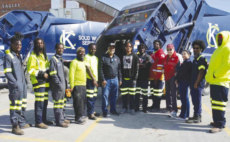 FIFTH DISTRICT SPRING CLEAN UP—KCMO Public Works Department employees (in reflective gear) pose with 5th District City Councilman Darrell Curls (center in jeans) and South Kansas City Alliance President John Sharp and SKCA Board Member Karissa Varga (3rd &amp; 2nd from right) at the drop-off site for unwanted household items at Ruskin High School during the annual 5th Council District spring cleanup on May 17 that the Alliance assists with.