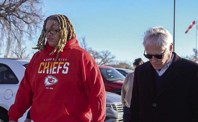 Deshaun Durham, left, and his attorney Barry Grissom, right, on Dec. 6, 2024, leave a Hutchinson prison after Durham’s sentence for a marijuana offense was shortened. (photo/Last Prisoner Project)