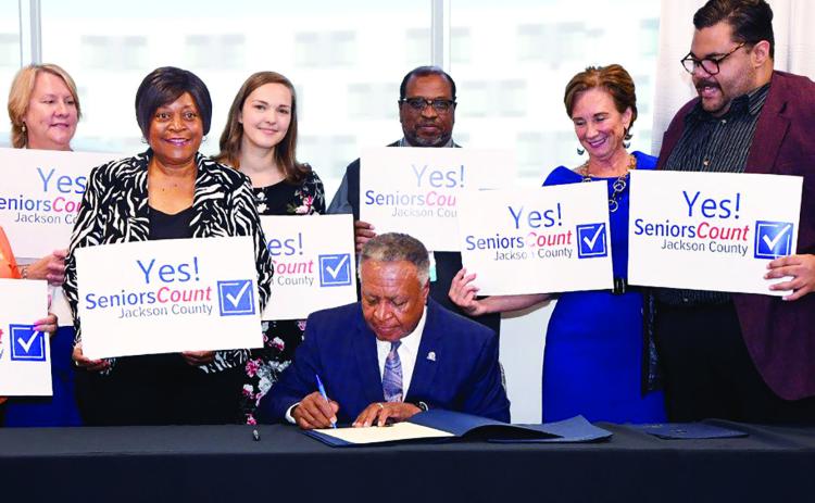 Jackson County Executive Frank White, Jr., signs the Jackson County Seniors Count ballot initiative.