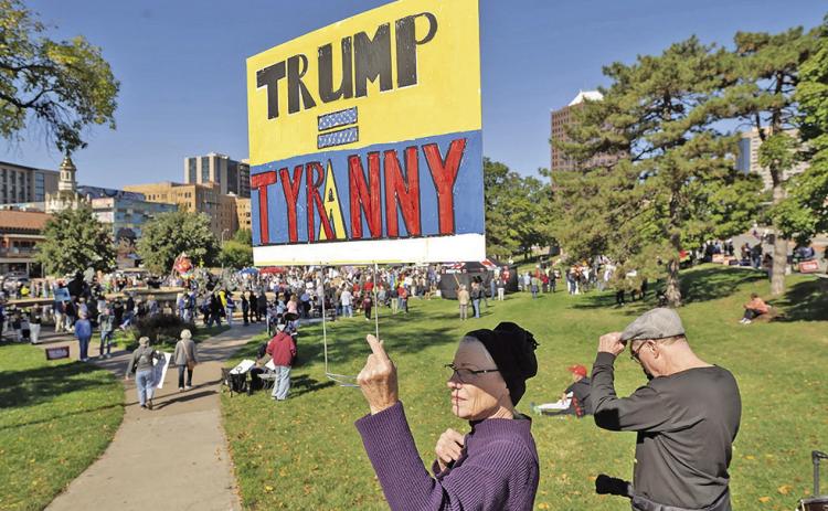 Stephanie Bradt, at left, and her brother Clint Bradt near the crowd gathered at a No Kings rally that drew thousands of people to Mill Creek Park east of the Country Club Plaza (Julie Denesha/KCUR)