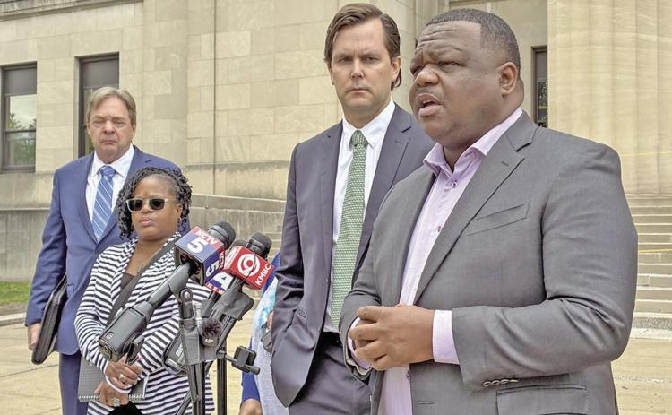 Erica Adair, Charles Adair's sister, and lawyers representing his family speak outside the Wyandotte County courthouse Wednesday after viewing body camera footage of the moments leading up to his death for the first time. (Jodi Fortino/KCUR 89.3)