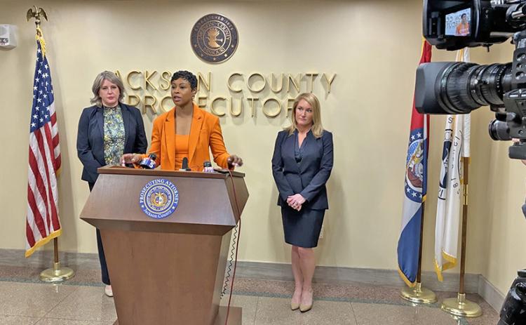 Jackson County Prosecutor Melesa Johnson talks to reporters on Tuesday, defending her office’s charging of one of the men accused in the fatal Super Bowl parade shootings in February 2024. Chief Trial Assistant Kristiane Bryant (left) and Assistant Prosecuting Attorney Hallie Schuman (right) handled the case. (Peggy Lowe/ KCUR 89.3)